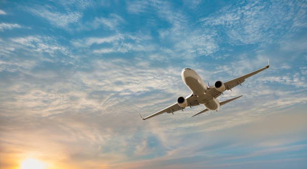 airplane flying over tropical sea at sunset antalya, turkey